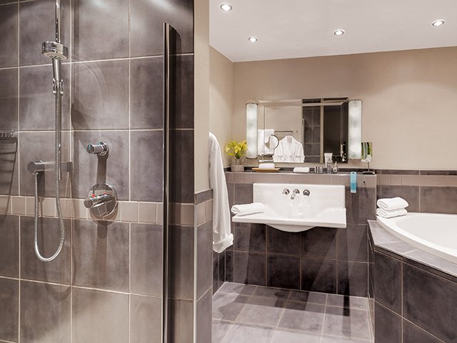 Suite: Bathroom with bath and shower