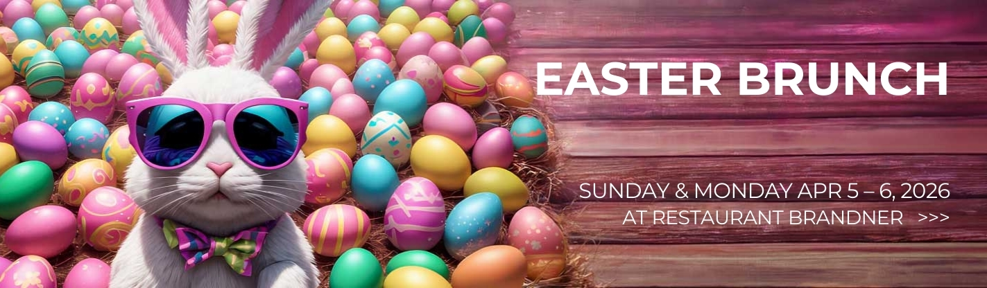 White bunny in sunglasses surrounded by colorful Easter eggs